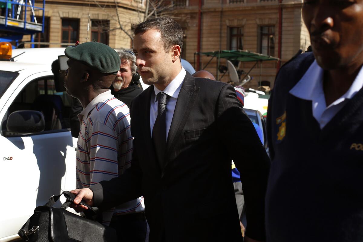South African Olympian Oscar Pistorius leaves court in Pretoria on Tuesday.