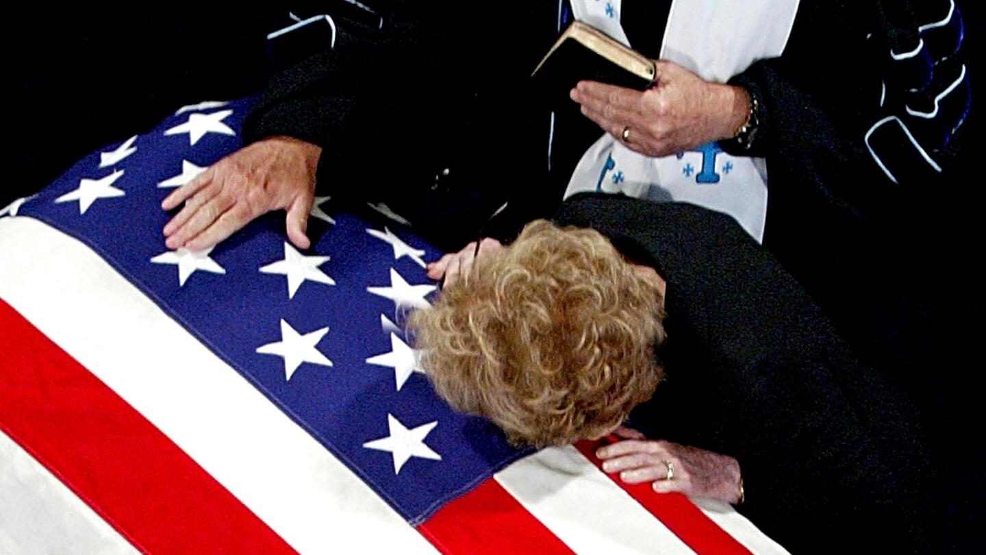 The former first lady lays her cheek on Ronald Reagan's casket after his death in 2004. His Alzheimer's diagnosis led her to become an advocate for stem cell research and hastened a reconciliation between her and her children.