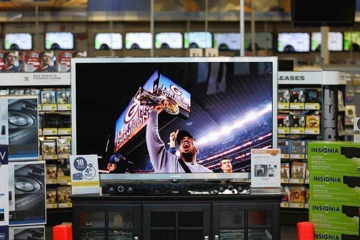 A 65-inch Samsung TV at Best Buy in Burbank shows the Green Bay Packers' Super Bowl win in 2011.