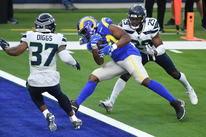 LOS ANGELES, CALIFORNIA NOVEMBER 15, 2020-Rams running back Malcolm Brown scores a touchdown against Seahawk defenders Quandre Diggs and D.J. Reed in the 2nd quarter at SoFi Stadium in Inglewood Sunday. (Wally Skalij/Los Angeles Times)