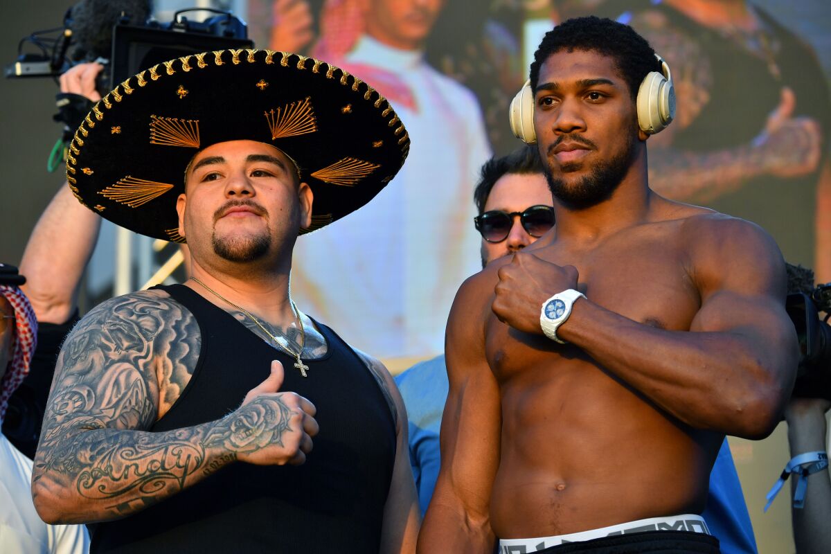 Mexican-American heavyweight boxing champion Andy Ruiz Jr (L) and British heavyweight boxing challenger Anthony Joshua pose during the official weigh-in in the Saudi capital Riyadh, on December 6, 2019, ahead of the upcoming "Clash on the Dunes". - The hotly-anticipated rematch between Ruiz Jr and British challenger Anthony Joshua is scheduled to take place in Diriya, near the Saudi capital on December 7. (Photo by Giuseppe CACACE / AFP) (Photo by GIUSEPPE CACACE/AFP via Getty Images)