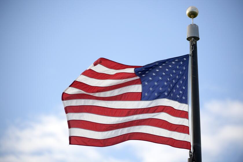 A United States flag flies during an NCAA golf tournament on Sunday, Oct. 20, 2019 in Vero Beach, Fla. (AP Photo/Phelan M. Ebenhack)