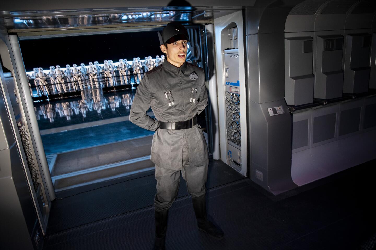 ORLANDO, FL --DECEMBER 03, 2019—A Disney Cast Member dressed as a member of the First Order leads guests into a hangar bay of a Star Destroyer, where 50 Stormtroopers greet riders, on Star Wars: Rise of the Resistance, during a press preview at Star Wars: Galaxy’s Edge at Disney’s Hollywood Studios, in Orlando, FL, Dec 03, 2019. The ride, opening this week in Florida and in mid-January in Anaheim, is billed as Disney's most ambitious ride ever and the key to ushering in the crowds to Galaxy's Edge.(Jay L. Clendenin / Los Angeles Times)