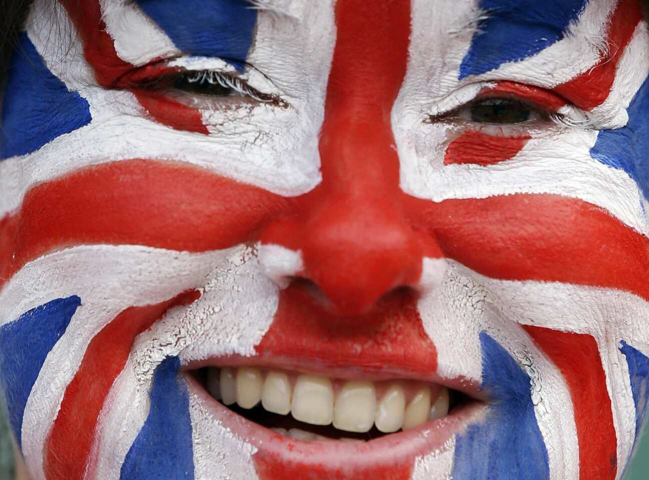 Tennis fan Kate Martin bears a version of the Union Flag painted on her face as she watches the men's singles bronze medal match during the 2012 London Olympics last Sunday.