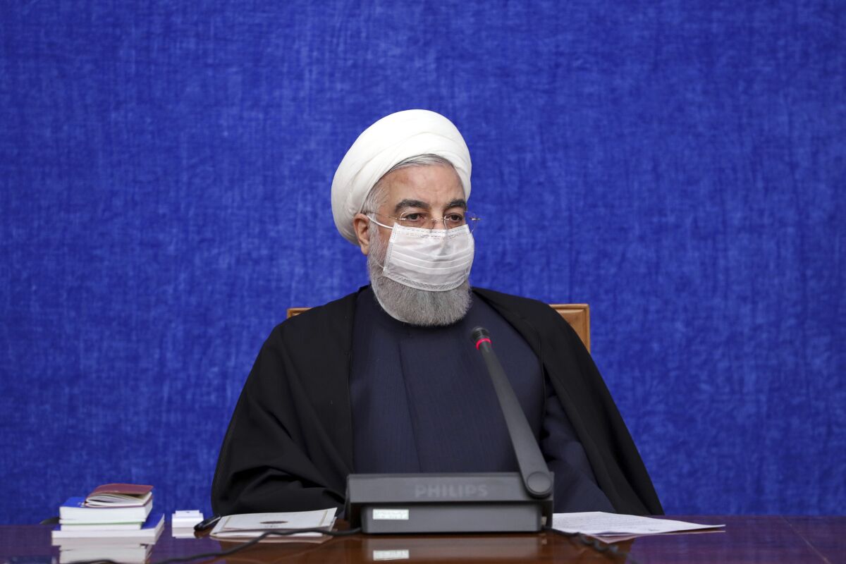 In this photo released by the official website of the office of the Iranian Presidency, President Hassan Rouhani speaks in a meeting in Tehran, Iran, Wednesday, Dec. 9, 2020. Rouhani said Wednesday that U.S. sanctions are making it difficult for Iran to purchase medicine and health supplies from abroad, including COVID-19 vaccines needed to contain the worst outbreak in the Middle East. (Iranian Presidency Office via AP)