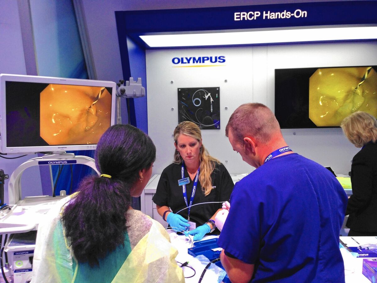 A showcase for Olympus products on the exhibit floor at the Digestive Disease Week conference in Washington, D.C., attracts a steady stream of doctors from across the country.