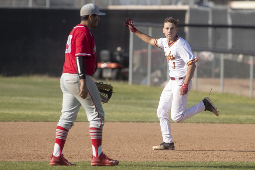 Estancia High's Garrett Palme celebrates after his walk-off hit in the bottom of the eighth inning lifted the Eagles to a 1-0 win over Savanna in the first round of the CIF Southern Section Division 5 playoffs at home on Thursday.