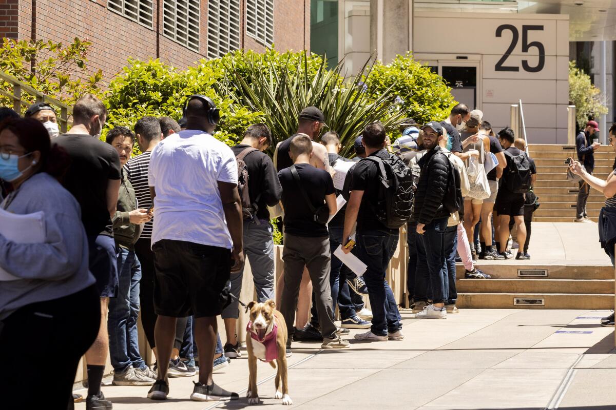 People wait in a line outside