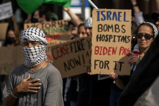 LOS ANGELES, CA-NOVEMBER 4, 2023, 2023:Musa Abdul Rahman, 21, left, joins other protesters, demanding an end to the Israeli invasion of Gaza during a pro-Palestinian rally outside the Israeli Consulate on Wilshire Blvd. in Los Angeles. (Mel Melcon / Los Angeles Times)