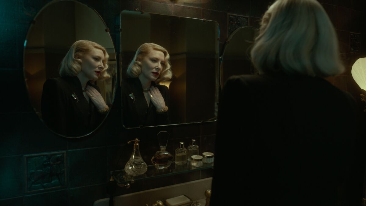 A woman with a blond bob is reflected in two mirrors 