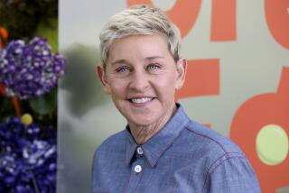 Ellen DeGeneres in a blue button up shirt 