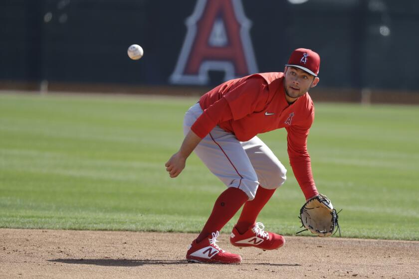 Los Angeles Angels' David Fletcher fields a ground ball during spring training baseball practice, Monday, Feb. 17, 2020, in Tempe, Ariz. (AP Photo/Darron Cummings)