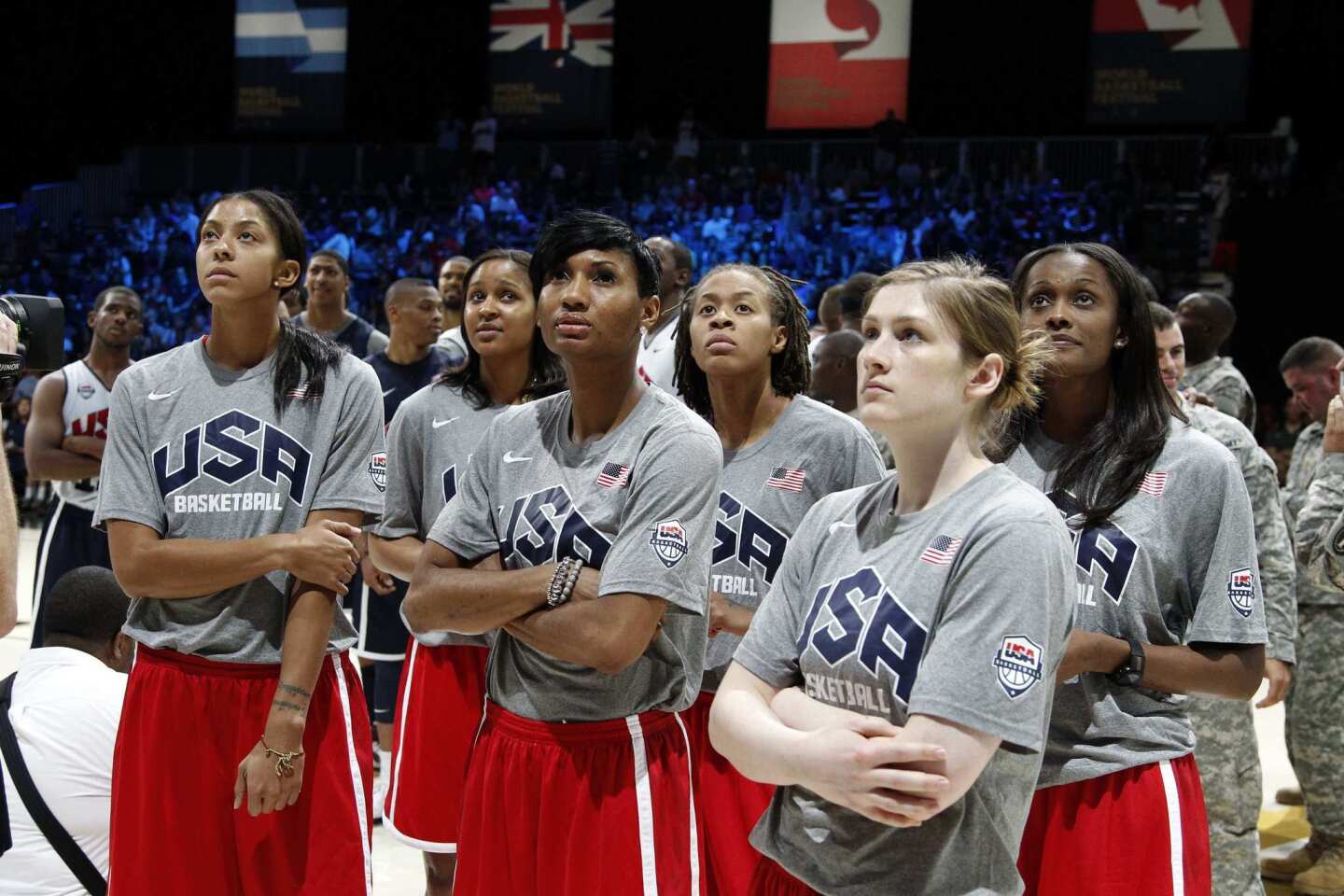 U.S. Women's Basketball Team members, from left, Candace Parker, Maya Moore, Angel McCoughtry, Seimone Augustus, Lindsay Whalen and Swin Cash watch a video before a men's practice in Washington on July 14.