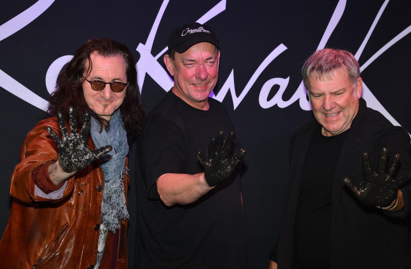 Geddy Lee, Neil Peart and Alex Lifeson of Rush, whose hits include "New World Man" and "Show Don't Tell."