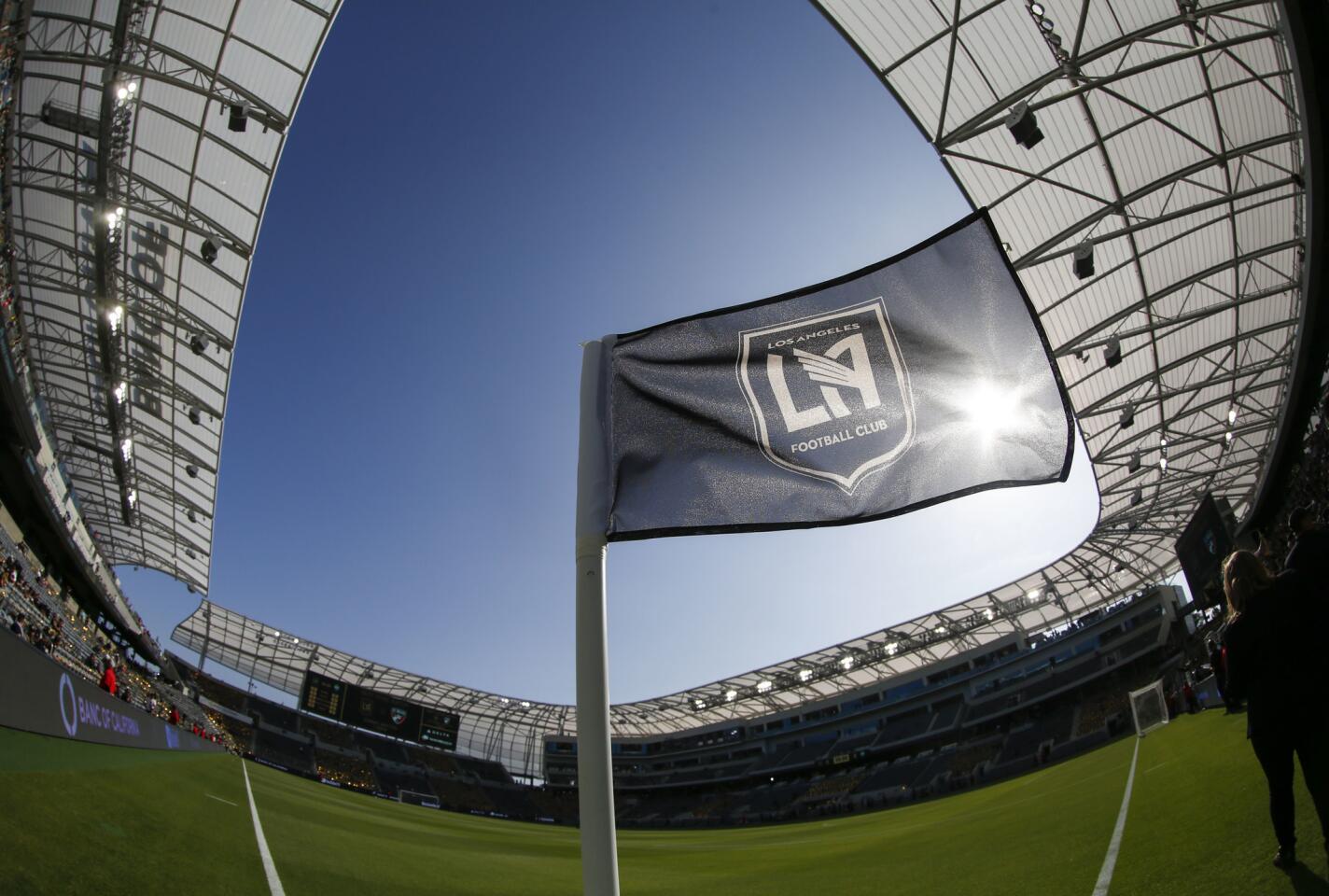 In this photo taken with a fisheye lens, a flag flies at the new Banc of California Stadium prior to an MLS soccer game between Los Angeles FC and the Seattle Sounders in Los Angeles, Sunday, April 29, 2018. (AP Photo/Ringo H.W. Chiu)