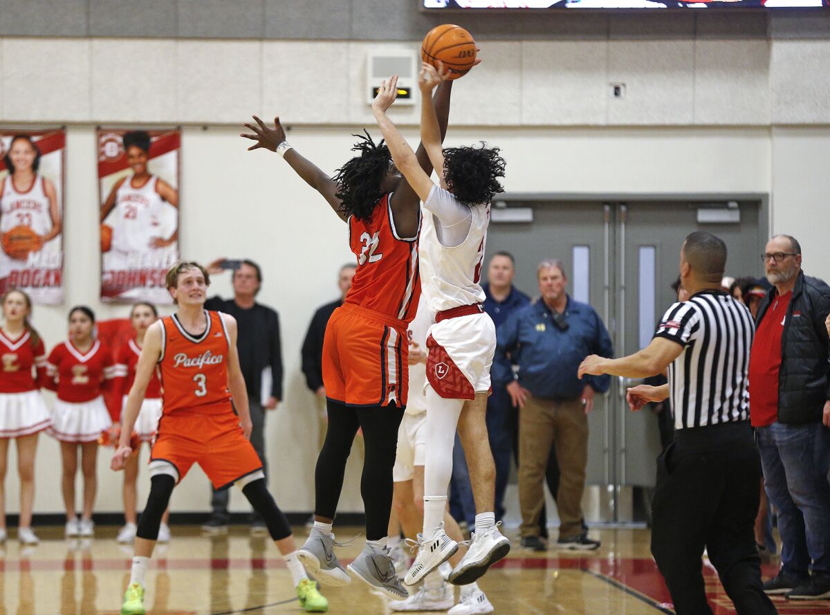 Pacifica Christian's EJ Spillman (32) makes a game-ending block on Zion Paleo on the last shot to secure the win Tuesday.