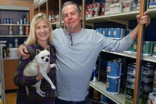 Kim and Mark Olinger, with their dog Daisy, are closing their family-owned paint store in Vista, Dura Paint, after 58 years, in order to retire. Mark's father and grandfather bought the downtown Vista building in 1958.