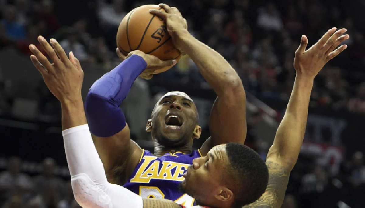 Kobe Bryant takes a shot over Portland's Damian Lillard in a game in November.