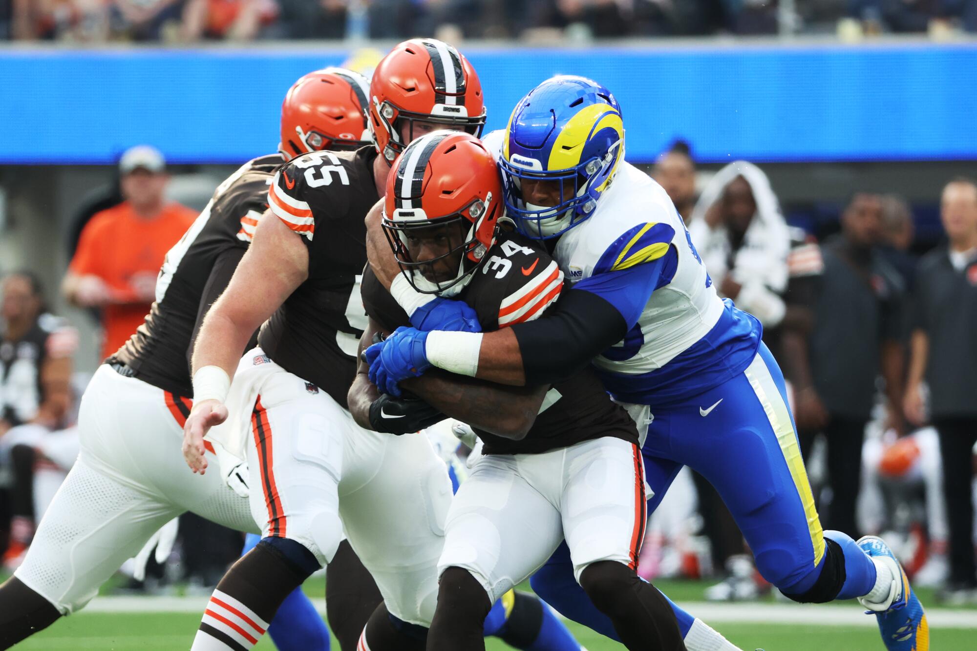 Rams defensive tackle Aaron Donald wraps up Cleveland Browns running back Jerome Ford for a loss.