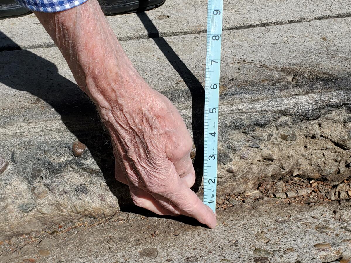 Dipping in the 2500 block of Torrey Pines Road has created a 5-inch-deep gap between the street and a nearby driveway.