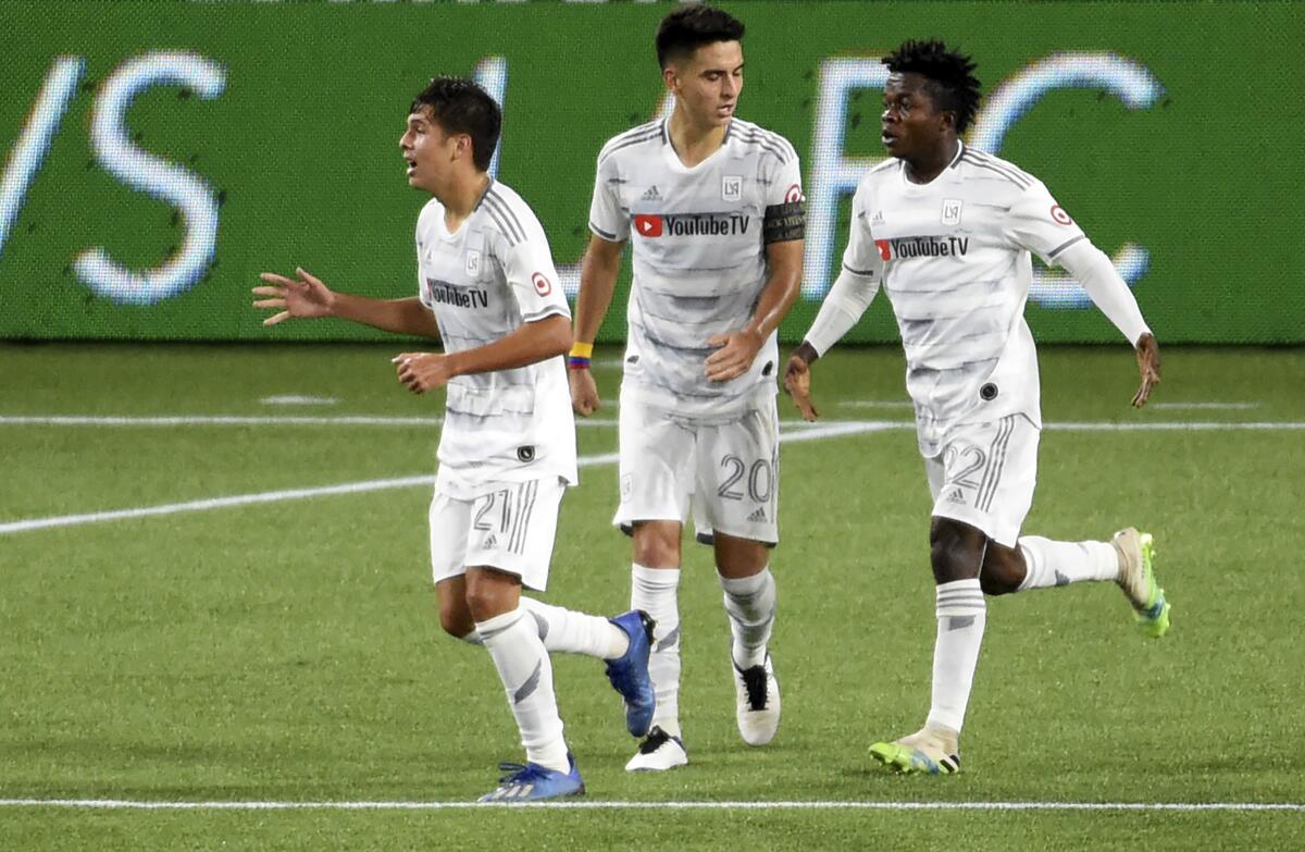 LAFC forward Christian Torres, left, celebrates with Eduard Atuesta and Kwadwo Opoku after scoring a goal Sunday.