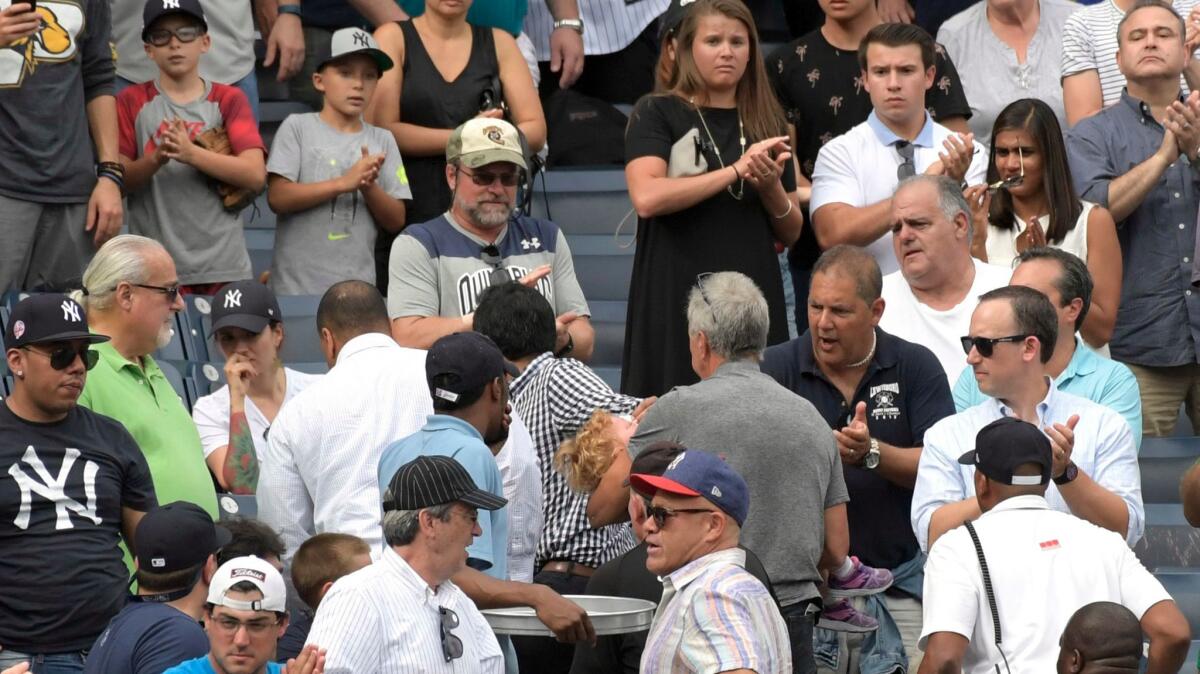 Fans reacts as a young girl is carried out of the stands after being hit by a line drive during a game between the New York Yankees and Minnesota Twins on Sept. 20.