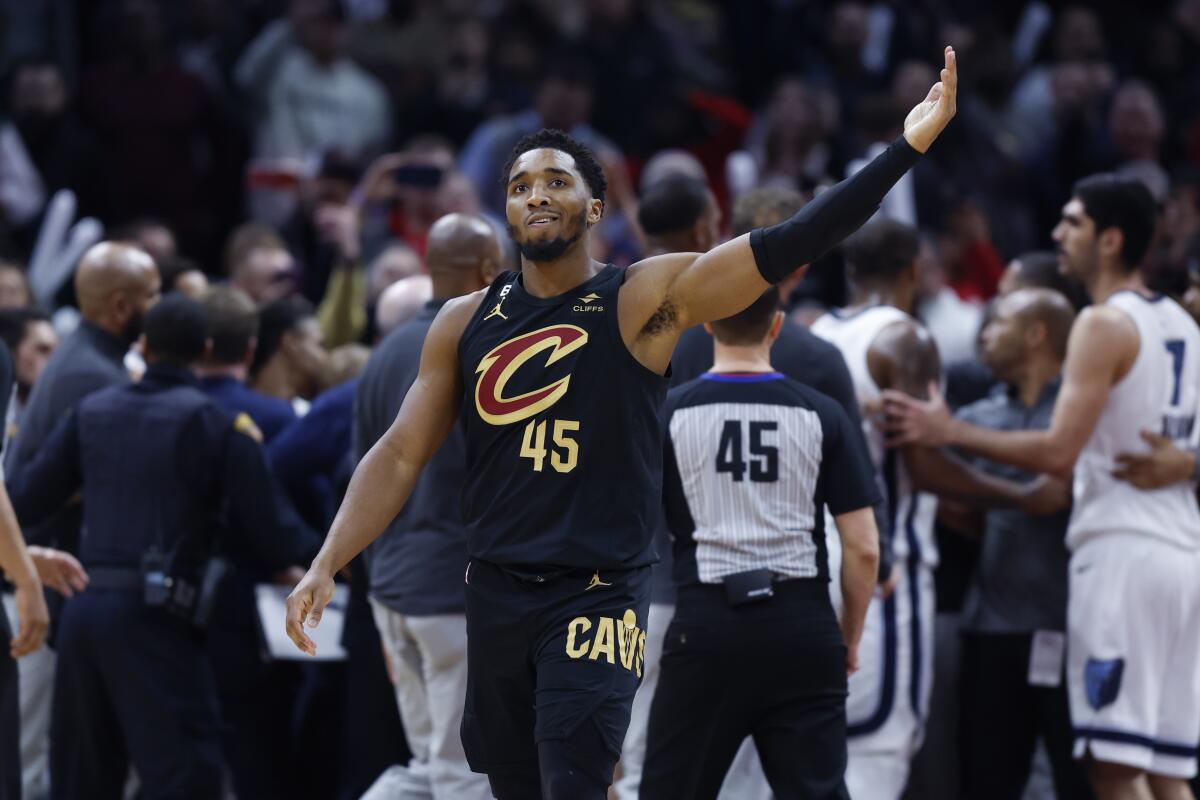 Cleveland Cavaliers guard Donovan Mitchell waves to the crowd after fighting with Memphis Grizzlies forward Dillon Brooks during the second half of an NBA basketball game, Thursday, Feb. 2, 2023, in Cleveland. Mitchell and Brooks were ejected from the game. (AP Photo/Ron Schwane)
