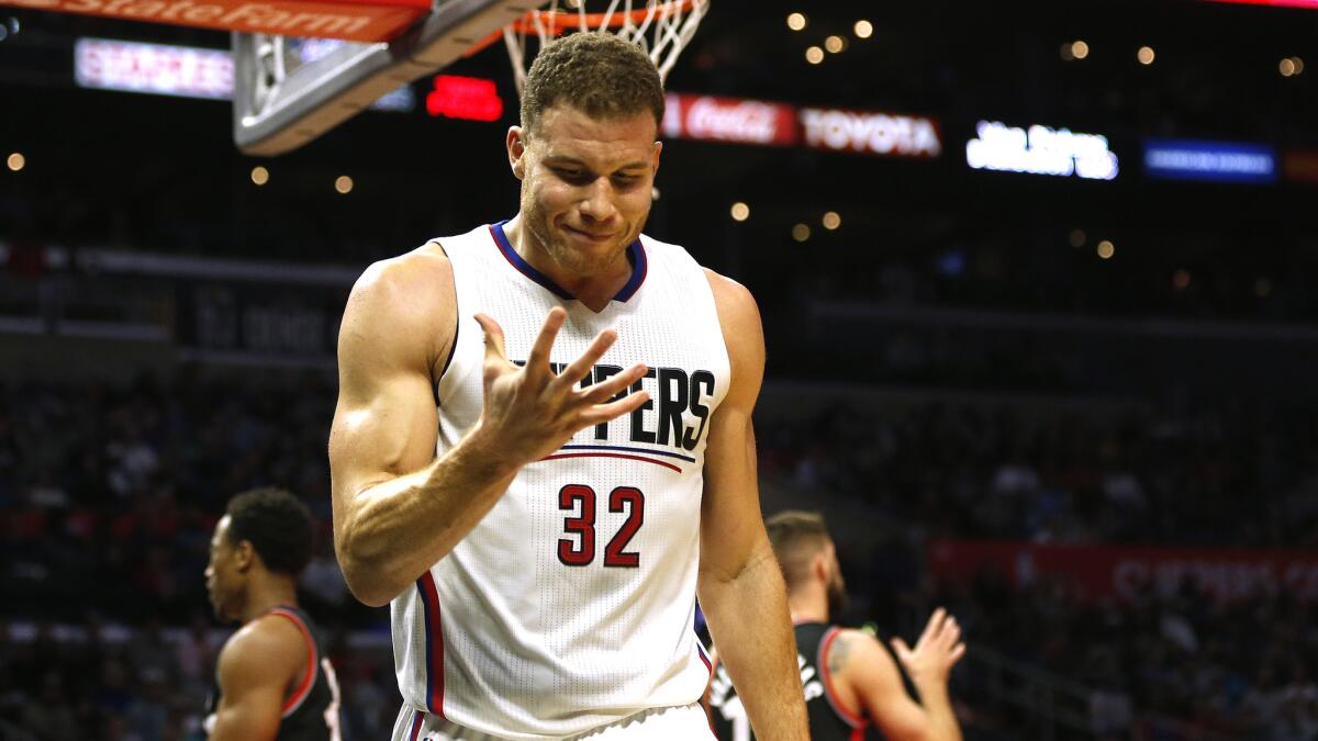 Clippers forward Blake Griffin looks down at his hand after being called for a foul.