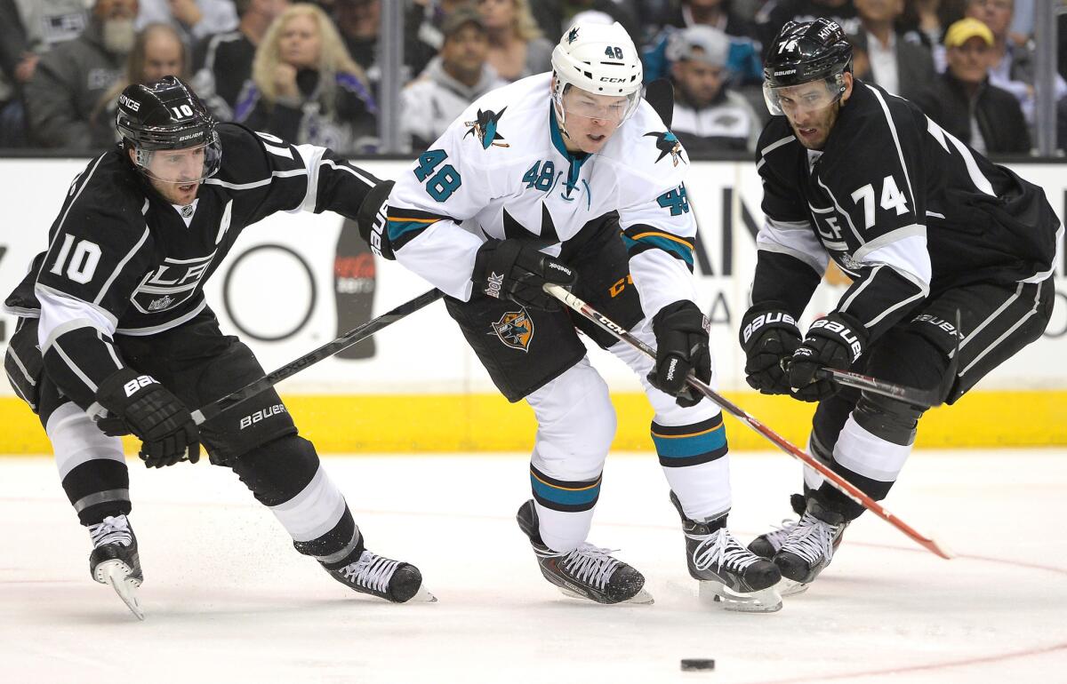 San Jose Sharks forward Tomas Hertl, center, controls the puck between Kings forwards Mike Richards, left, and Dwight King during the Kings' loss in Game 3 of the Western Conference quarterfinals Tuesday. The Kings played better in Game 3, but they still didn't win.