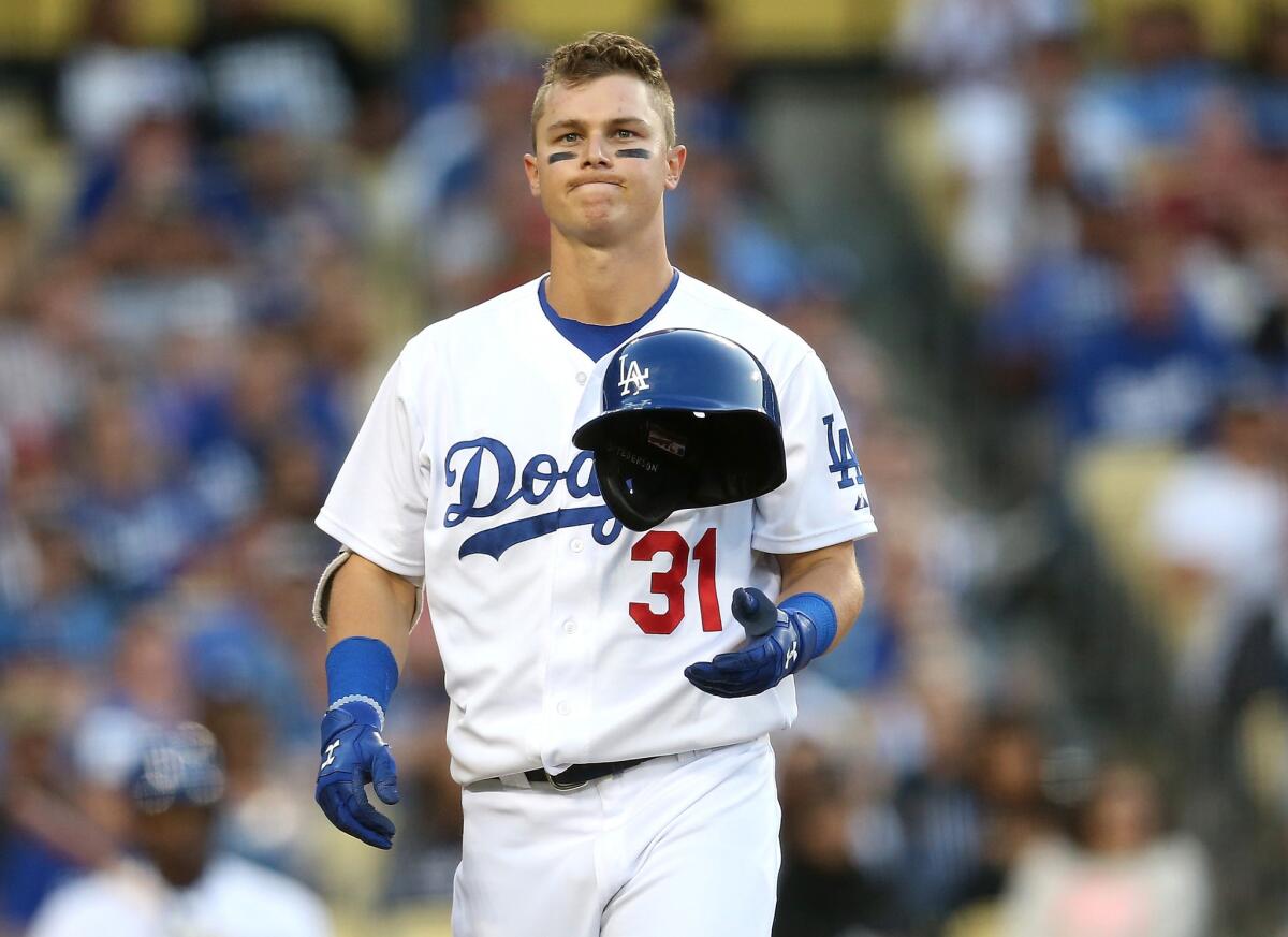 Dodgers center fielder joc Pederson heads back to the dugout after getting called out on strikes in the seventh inning against the Cardinals on Sunday night.