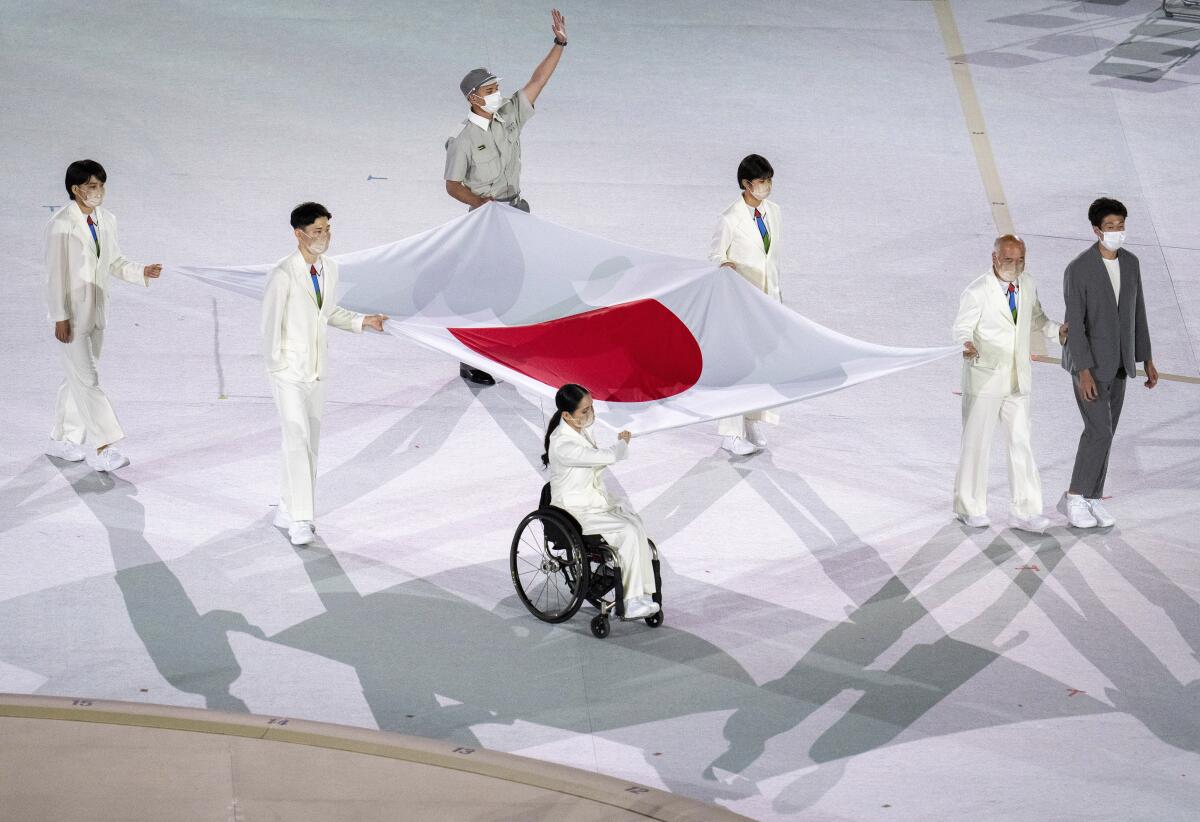 Japanese athletes carry their country's flag into the Olympic Stadium at the start of the Paralympic Games in Tokyo.