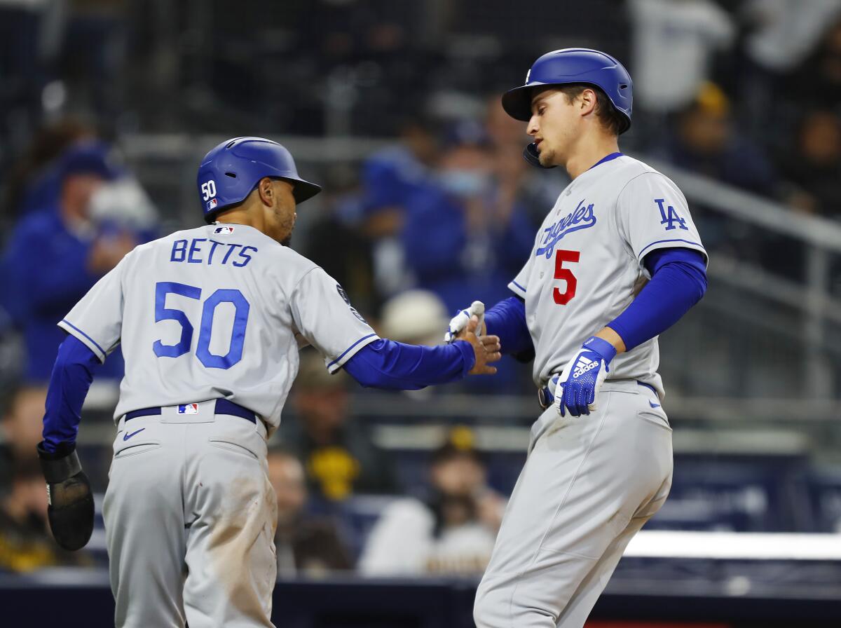 Corey Seager, right, celebrates with Mookie Betts after hitting a two-run home run for the Dodgers.