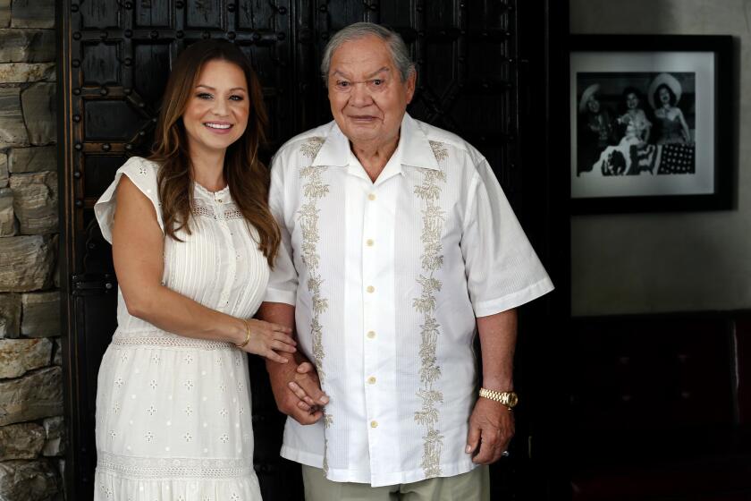 Second-generation Casa Vega owner Christy Vega Fowler holds hands with her father, Rafael "Ray" Vega, the founder of the 60-year-old restaurant in Sherman Oaks.
