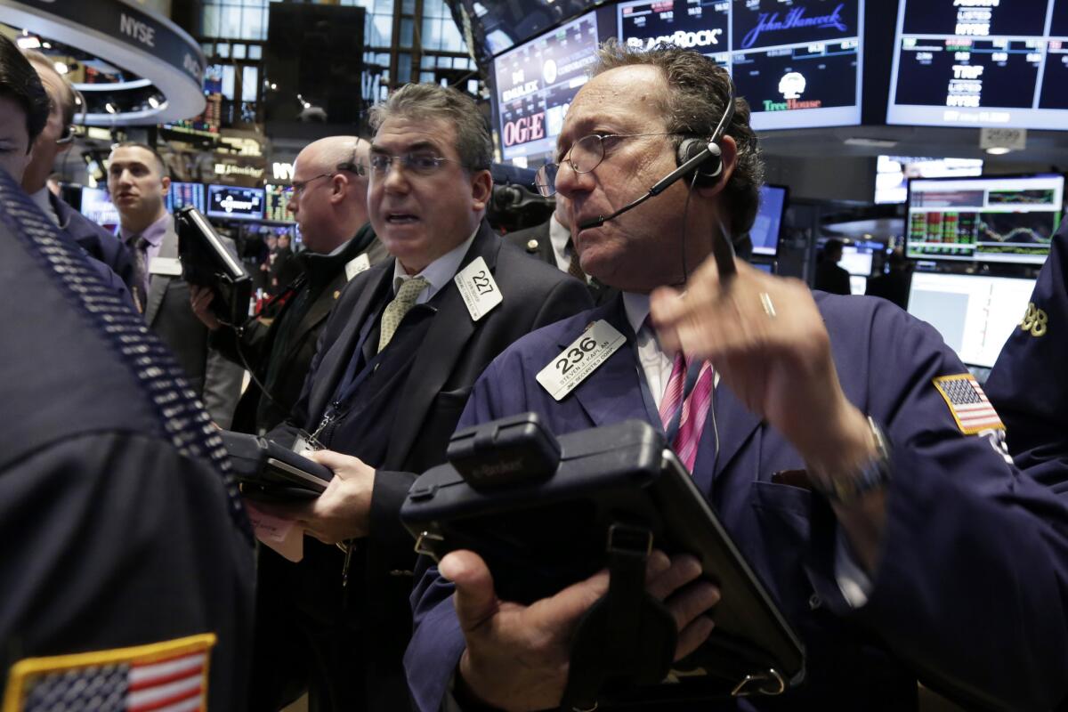 Traders work on the floor of the New York Stock Exchange, where on Thursday stocks drifted lower as energy stocks were among the biggest decliners.
