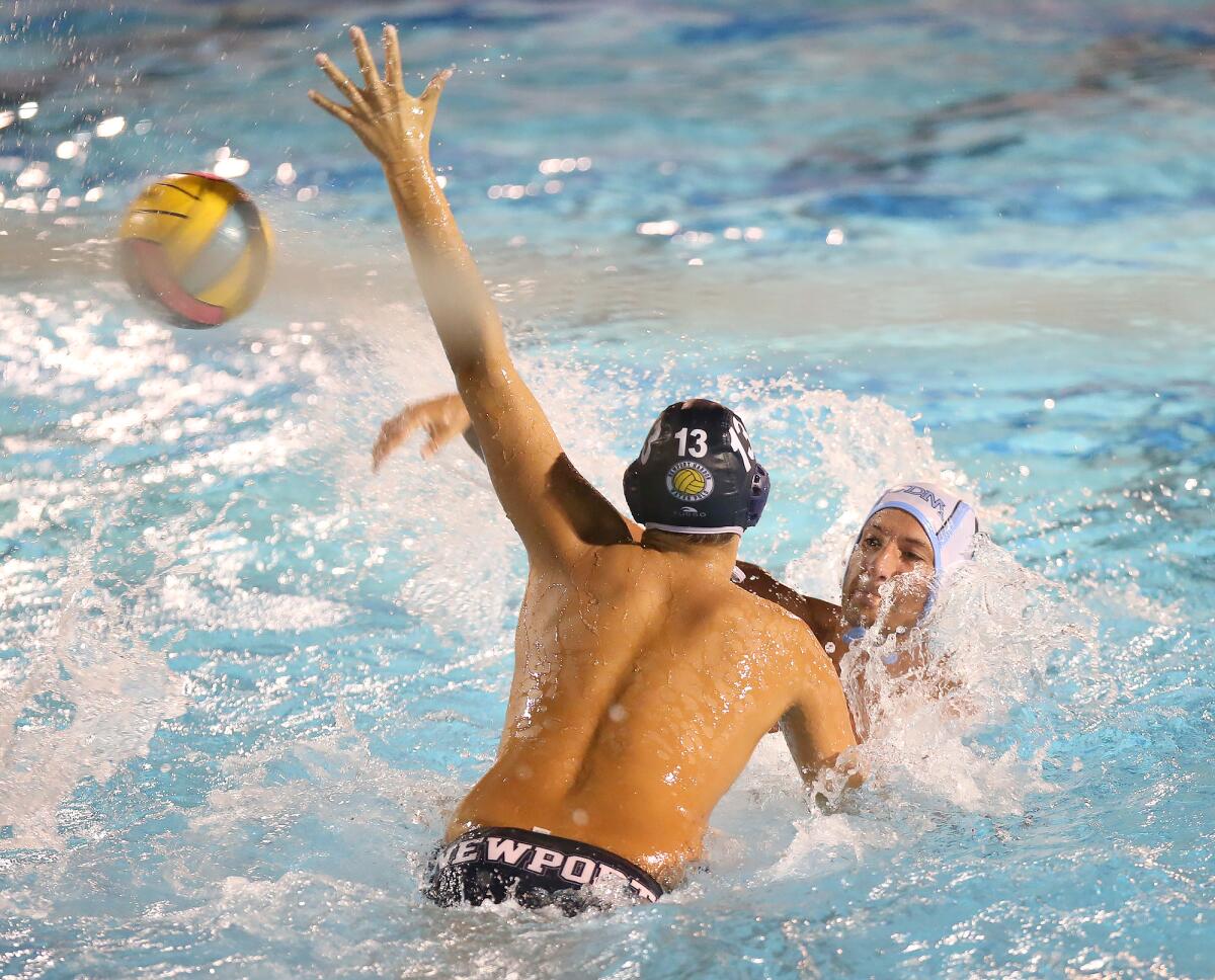 Newport Harbor's Ben Liechty (13) gets in the way of a pass by Corona del Mar's Tyler Harvey in the Battle of the Bay match on Wednesday.