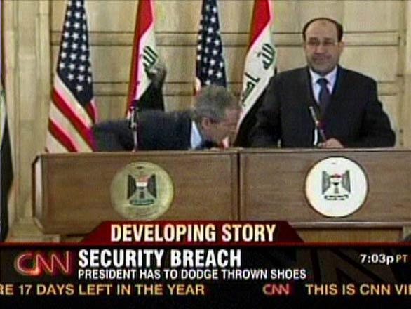 A screen grab from CNN shows President Bush ducking as a journalist hurled two shoes at him during a news conference with Prime Minister Nouri Maliki in Baghdad. "This is a gift from the Iraqis. This is the farewell kiss, you dog," Muntather Zaidi shouted at Bush as he threw his footwear. Neither shoe hit its target.