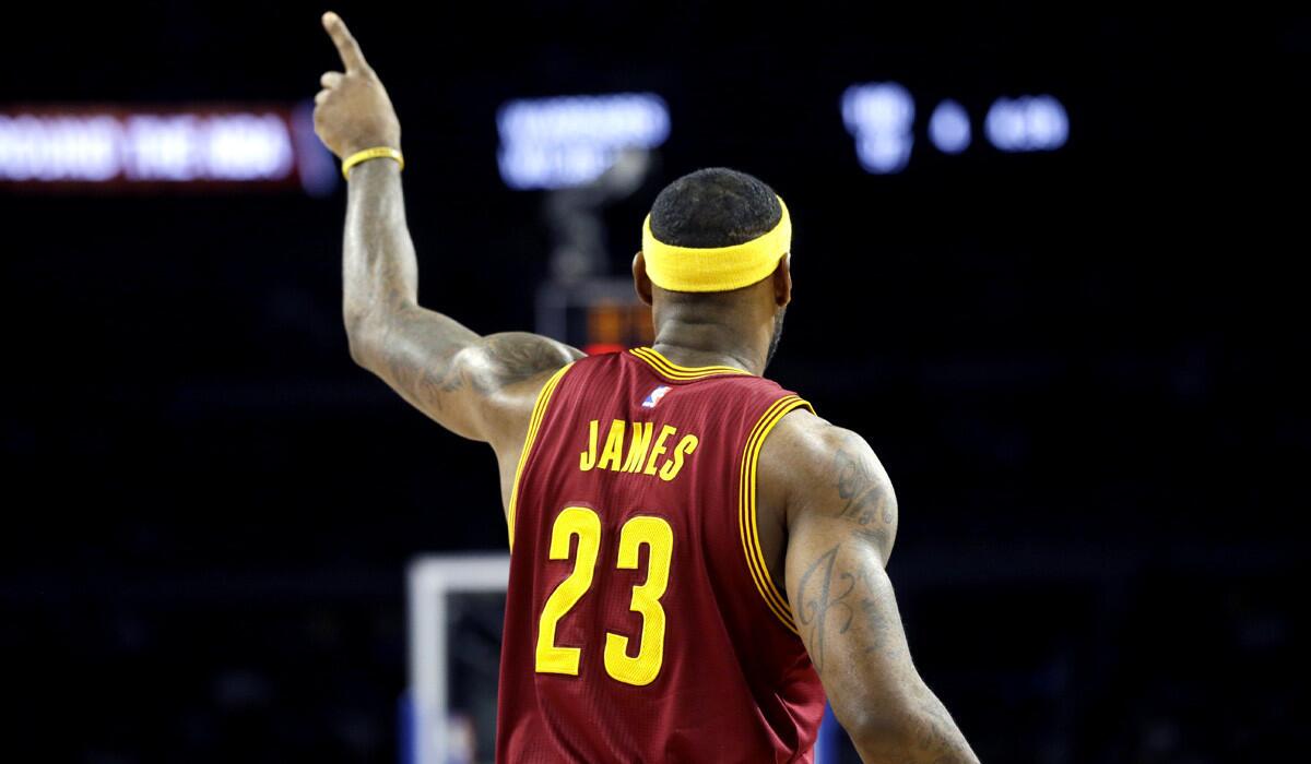 Cleveland Cavaliers forward LeBron James signals to his team during a 102-93 victory over the Detroit Pistons on Tuesday.