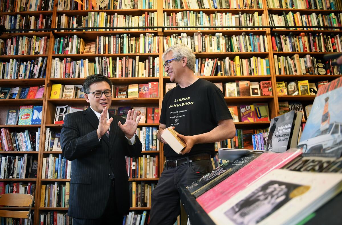 Gubernatorial candidate John Chiang, left, visits with David Kipen at his lending library, Libros Schmibros, in Boyle Heights on June 6.