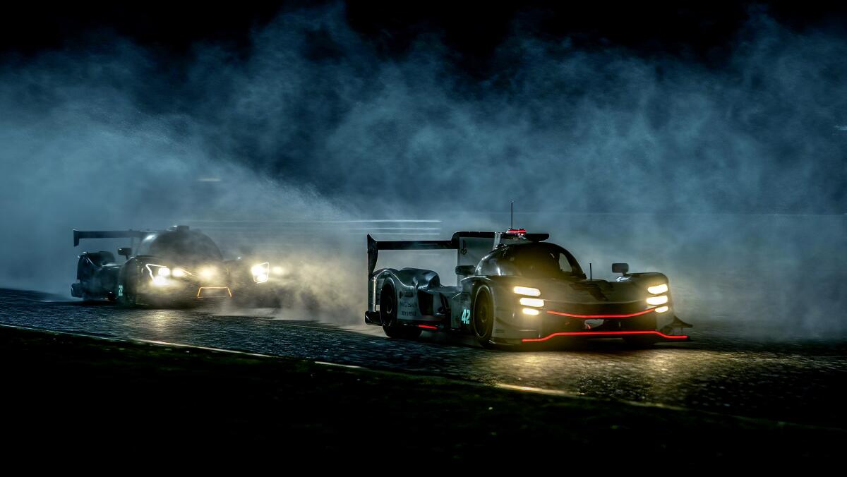 Cars jockey for position in a dark fog.