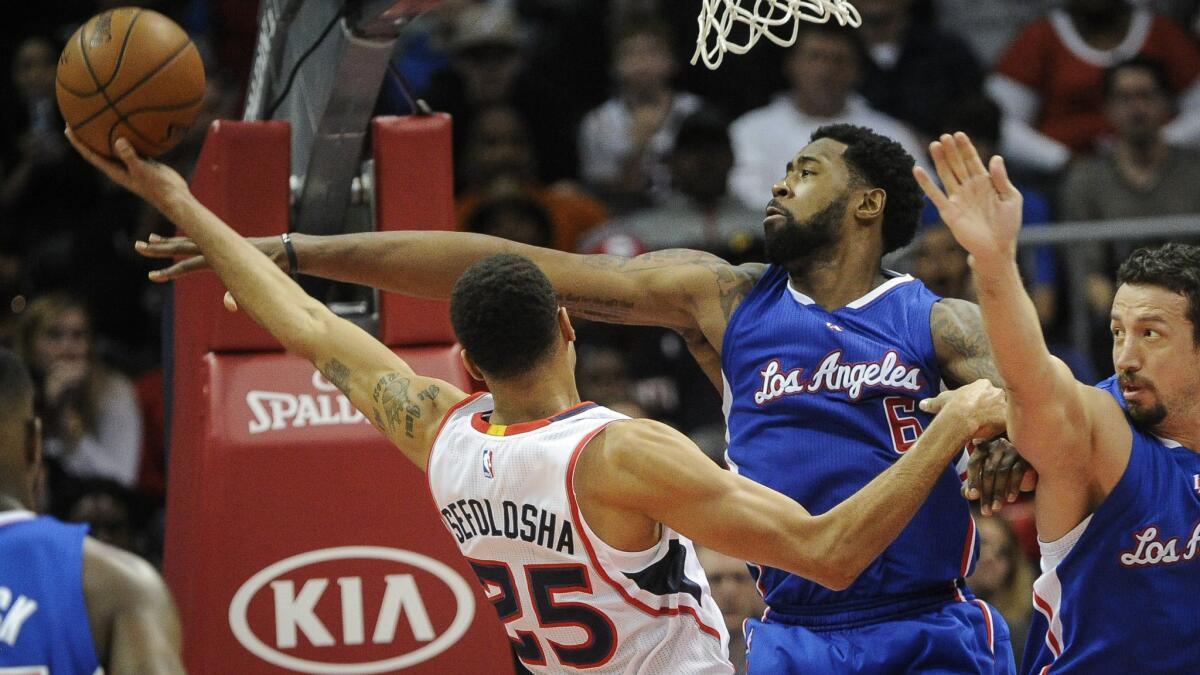 Atlanta Hawks guard Thabo Sefolosha, left, tries to shoot over Clippers center DeAndre Jordan during the Clippers' 107-104 loss on Dec. 23.