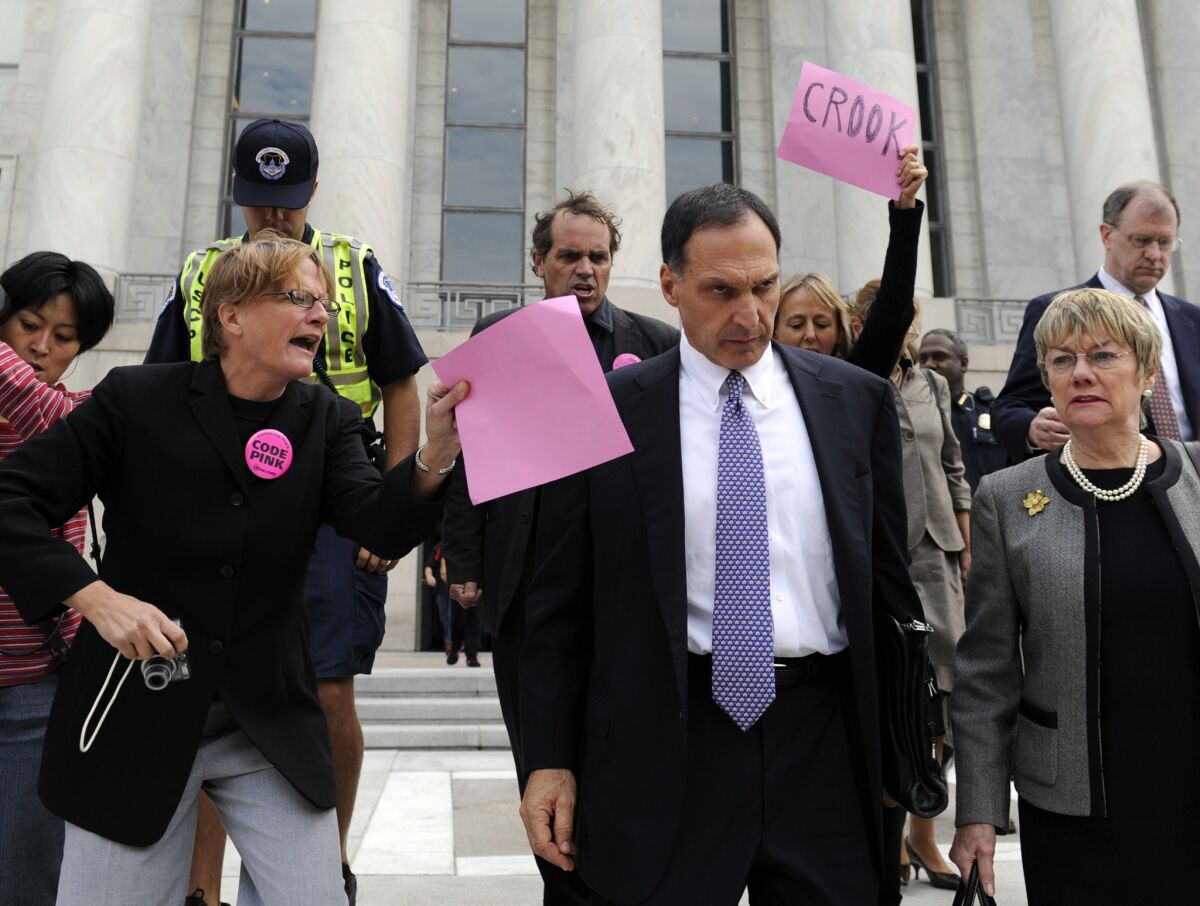 In this Oct. 6, 2008 file photo, Lehman Brothers Holdings Inc. Chief Executive Richard Fuld, front center, is heckled by protesters as he leaves Capitol Hill in Washington after testifying before a House committee on his company's collapse. A new study says he was among the country's best-paid CEOs for eight straight years -- until Lehman disintegrated.