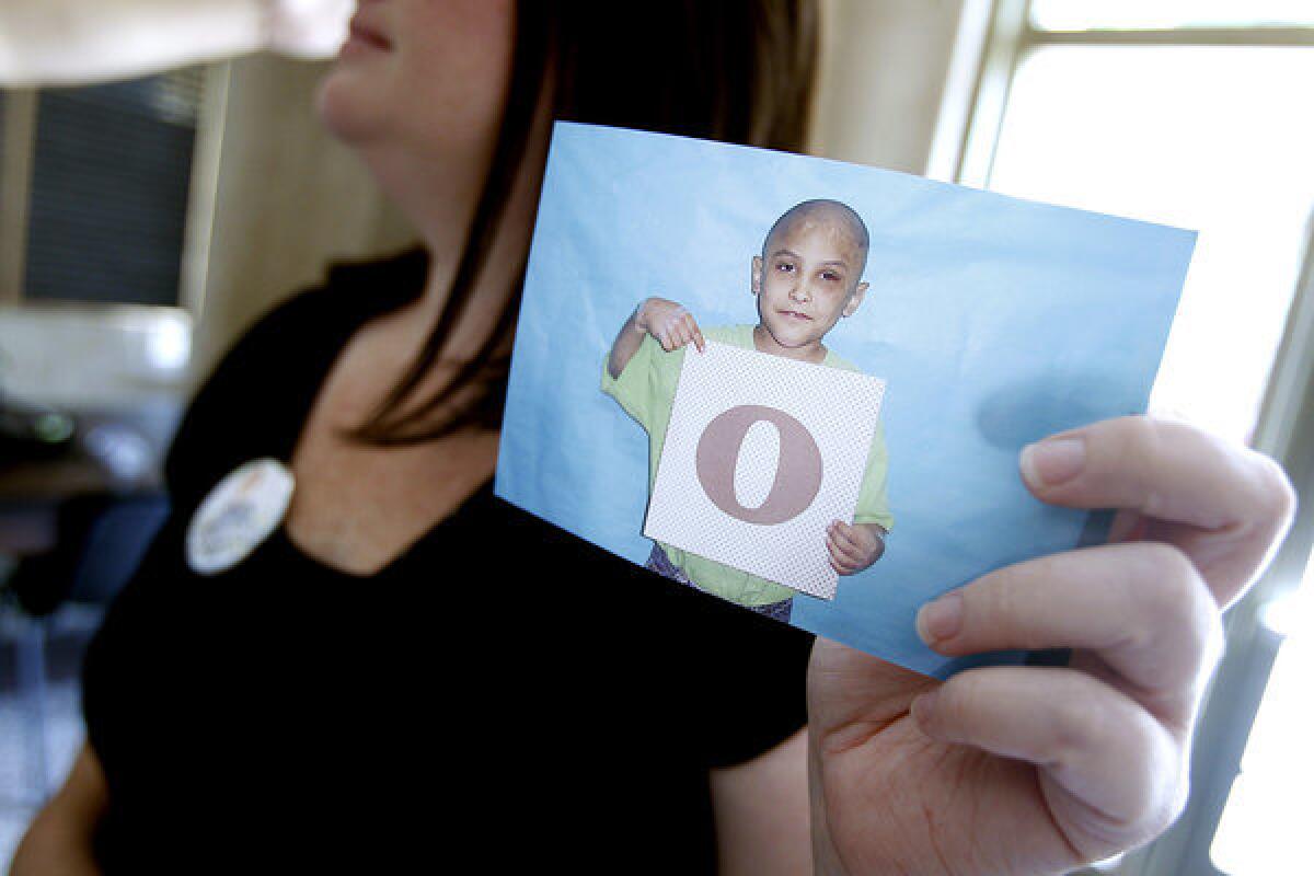 Kellee Vazquez of Santa Clarita, a concerned citizen, holds a photo of Gabriel Fernandez, an 8-year-old boy who police allege was tortured and killed by his mother and her boyfriend.