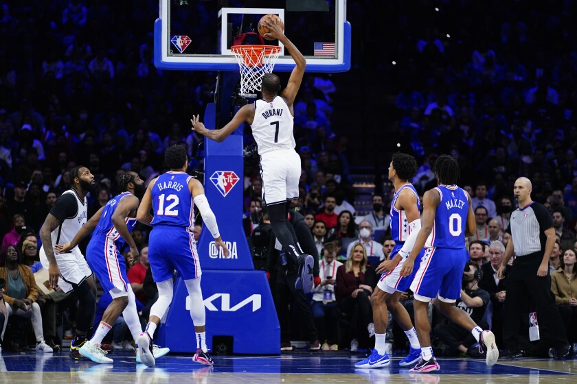 Brooklyn Nets' Kevin Durant (7) goes up for a dunk during the first half of an NBA basketball game against the Philadelphia 76ers, Thursday, March 10, 2022, in Philadelphia. (AP Photo/Matt Slocum)