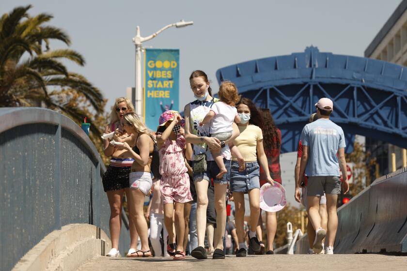 SANTA MONIA, CA - MARCH 29: A number of people visiting the Santa Monica Pier ebs and flows as people take advantage of the warm weather during the COVID-19 Spring break in Southern California Monday. Santa Monica Pier and Promenade on Monday, March 29, 2021 in Santa Monia, CA. (Al Seib / Los Angeles Times).