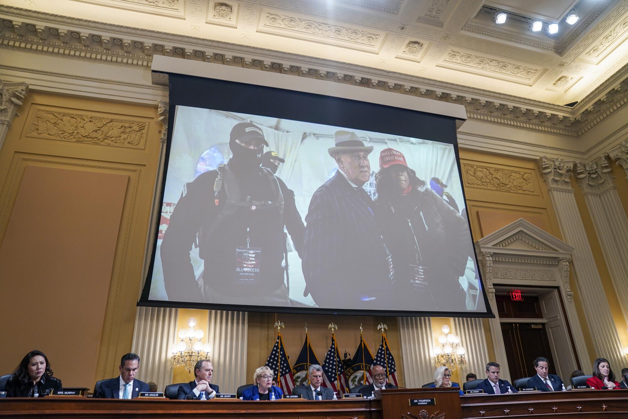 A photo of Roger Stone, former advisor to Donald Trump, with Oath Keepers members is projected during a hearing Oct. 13.