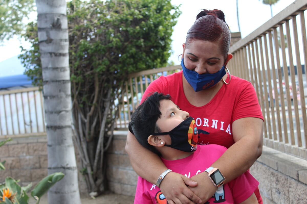 Maywood resident Gabriela Rangel, a 37-year-old mother who suffers from multiple sclerosis, holds her daughter Arleth