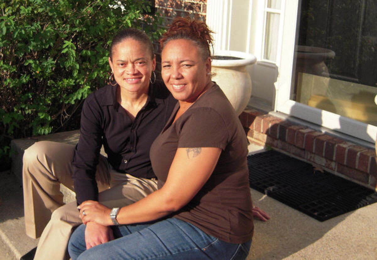 Irene Huskens, right, and her partner, Leia Burks, sit on the front porch of their home in Bowie, Md. Huskens has the wedding venue picked out: a charming bed-and-breakfast in southern Maryland.