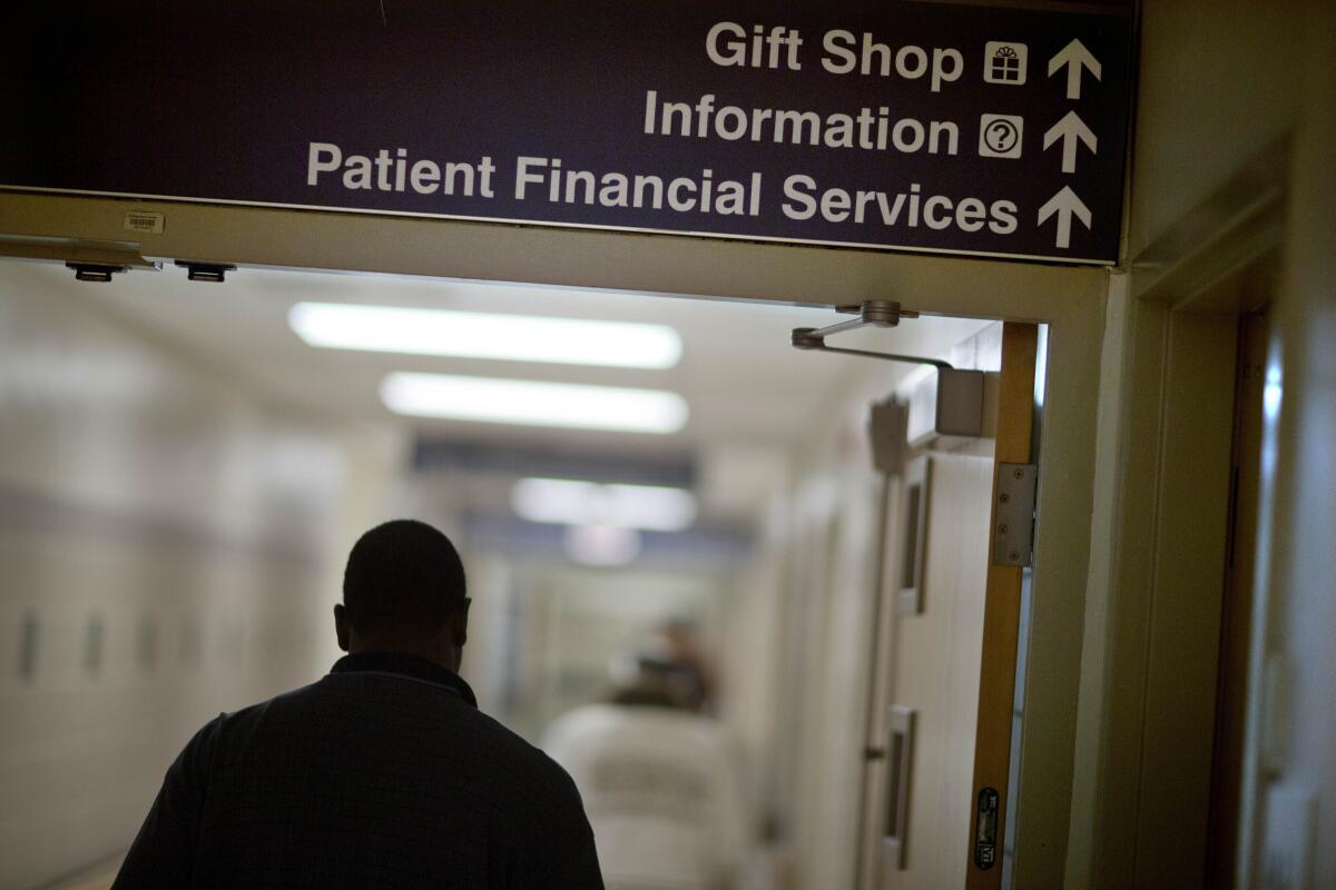 A sign points visitors toward the financial services department at a hospital.