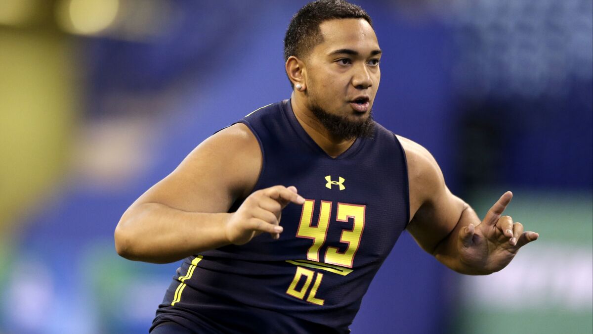 Utah offensive lineman Sam Tevi runs a drill at the NFL combine in March 3.