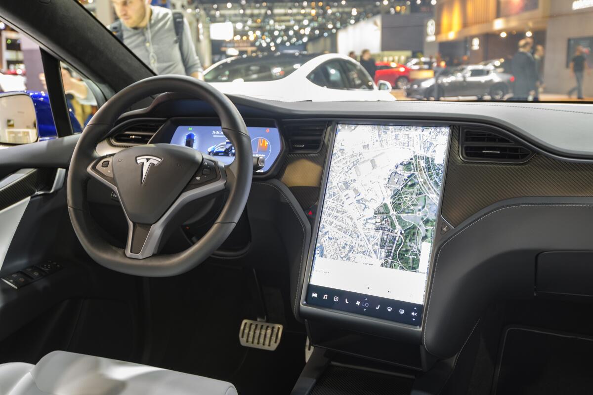 Interior on a Tesla Model X full electric luxury crossover SUV car with a large touch screen 